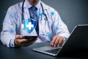A medical professional working on security-related tasks on his device.
