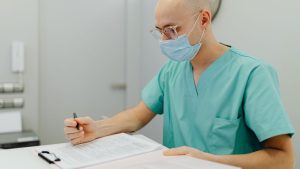 A dentist reviewing policy documents regarding Dentist Liability Insurance.